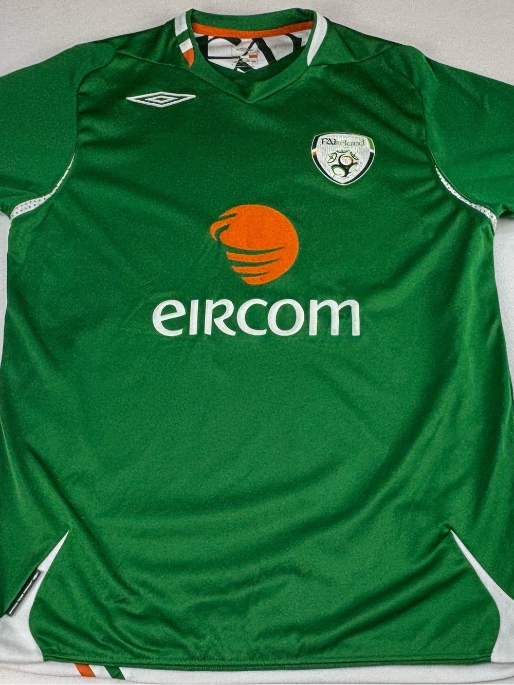 Umbro Kids Green Football Jersey with Orange Sponsor Logo
